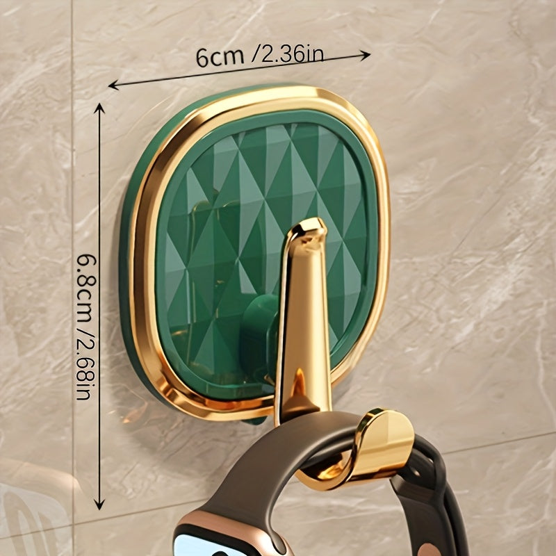 A Stylish Golden Wall-Mounted Hook for Robes And Towels Made of Rust-Resistant Plastic, Featuring a Chic Black Diamond Design. It Has a Strong Adhesive Suitable for Kitchens, Bathrooms, And for Hanging Clothes Or Keys, Utility Hooks