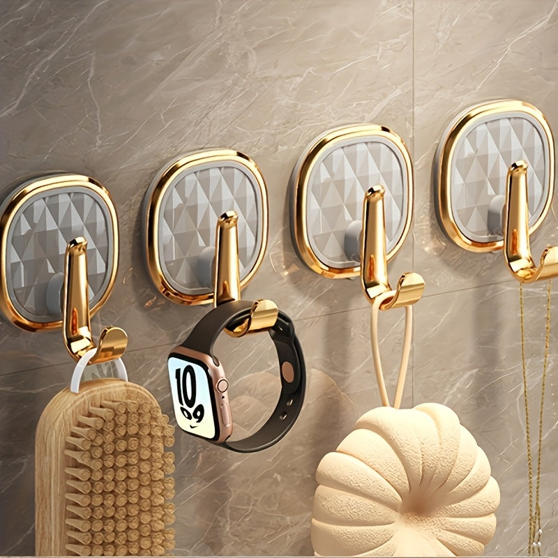 A Stylish Golden Wall-Mounted Hook for Robes And Towels Made of Rust-Resistant Plastic, Featuring a Chic Black Diamond Design. It Has a Strong Adhesive Suitable for Kitchens, Bathrooms, And for Hanging Clothes Or Keys, Utility Hooks